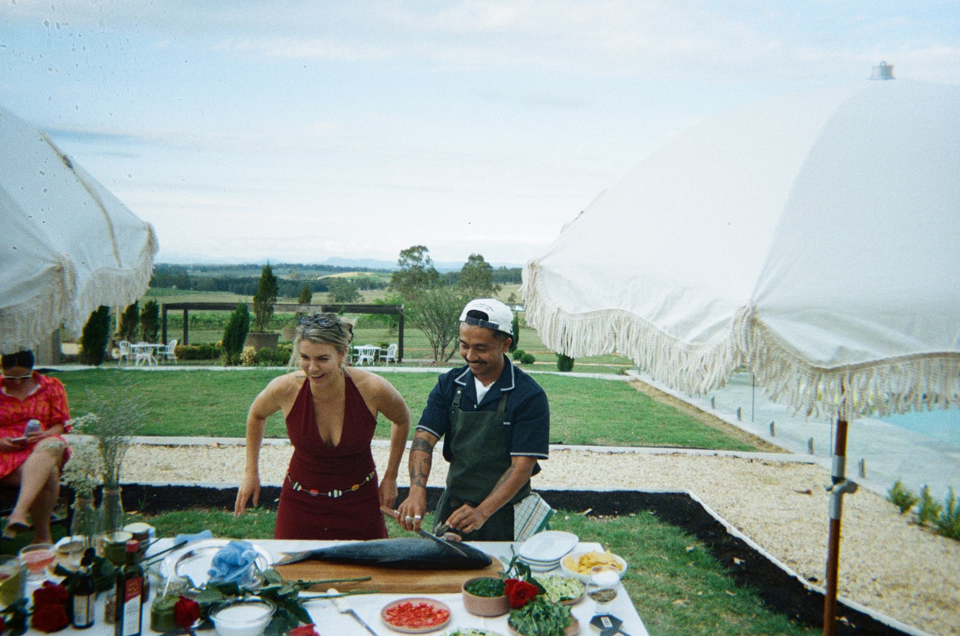 Breaking down tuna on the lawn, vines behind